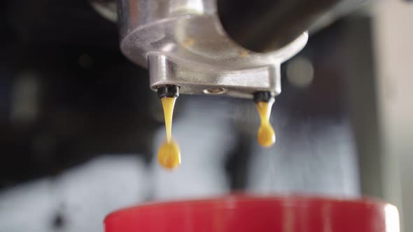 4k Slow motion B Roll of Pouring coffee stream from machine in cup.