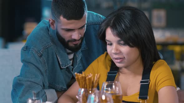 Couple discussing cellphone's apps