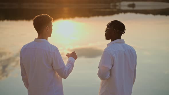 Handsome Young Men Spend Sunset at the Beach Vaping and Drinking
