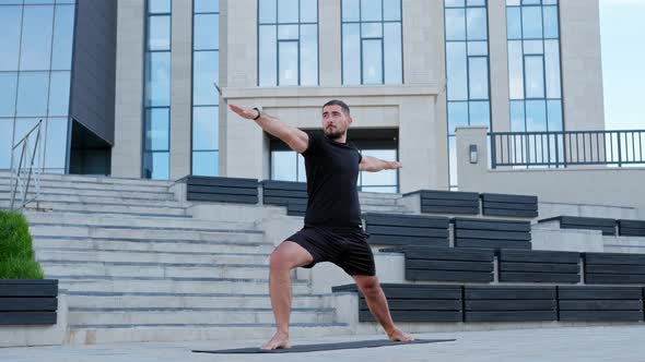 Man athlete practices yoga exercises, stretches.