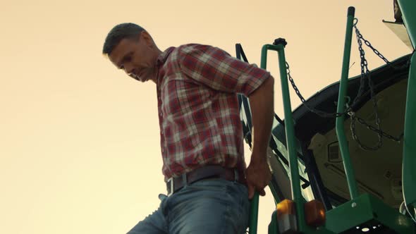 Driver Get Out Tractor Cabin at Sunlight alt