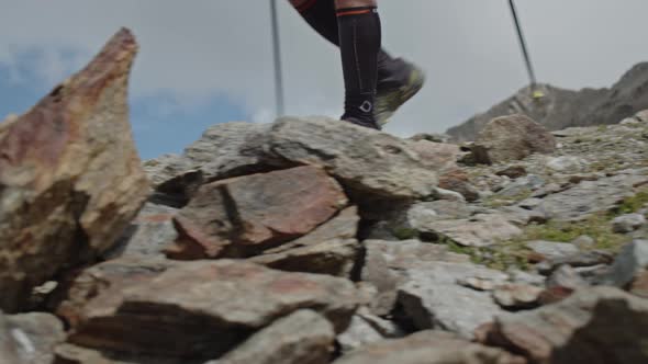 Man Running in a Big Mountains with Pole Sticks