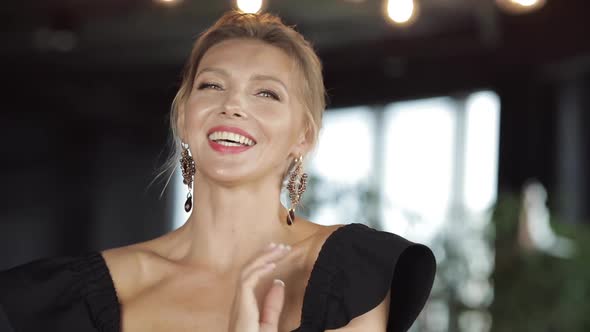 Attractive Lady in Black with Beautiful Earrings.