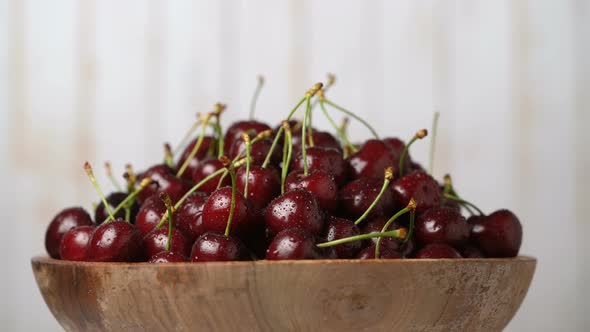 Fresh Ripe Juicy Cherries in a Wooden Bowl Rotation Loopable Food Background Gastronomy Concept