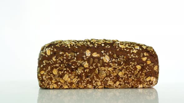 Fresh Wheat Bread With A Sprinkle Of Sunflower Seeds And Oatmeal On A White Background alt