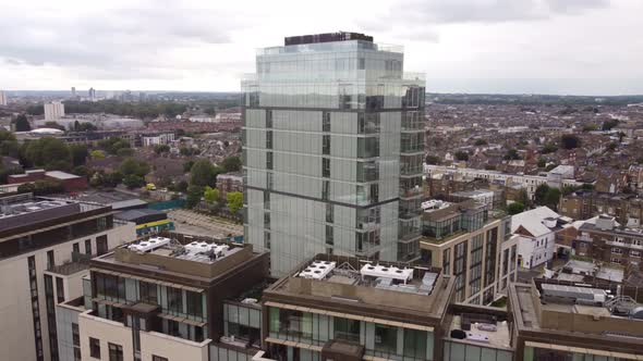 Drone Footage of a Glass Skyscraper Surrounded By Apartment Buildings