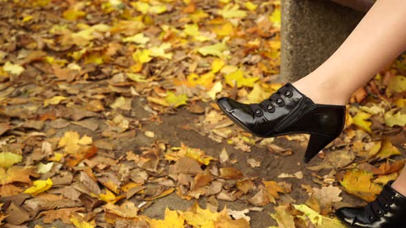 Woman Unzipping On The Black Shoe