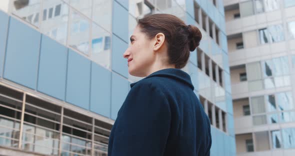Low Angle View of Successful Business Lady Standing Outside Office Building alt