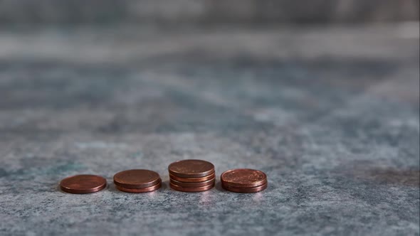 Growing coin stack in stop motion. Coin stack stop motion.