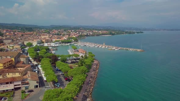 Aerial View of Boats and Coast of Lake Garda, Italy. Flying Over Boats and Shoreline of Lago Di alt