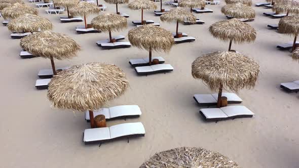 Aerial view of beach umbrellas and sunbeds on sand beach