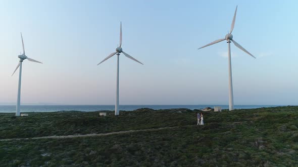 Wind Turbines And Couple Walking Aerial View 