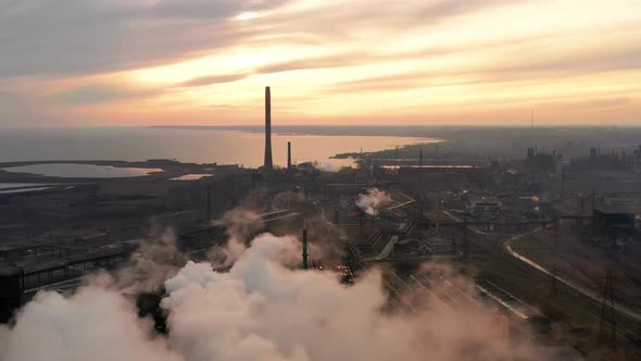 Aerial. GLOBAL WARMING. View of High Chimney Pipes with Grey Smoke. Pipes Pollute Industry