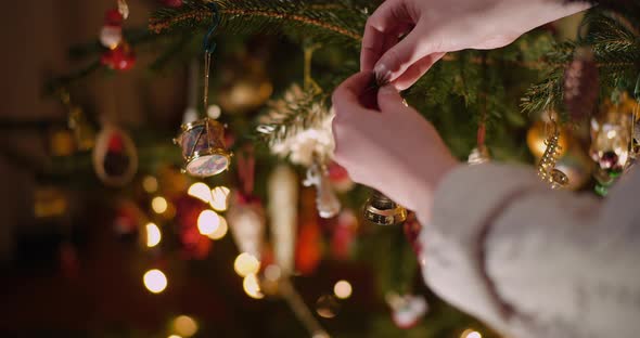 Woman Decorating Beautiful Christmas Tree in Living Room alt