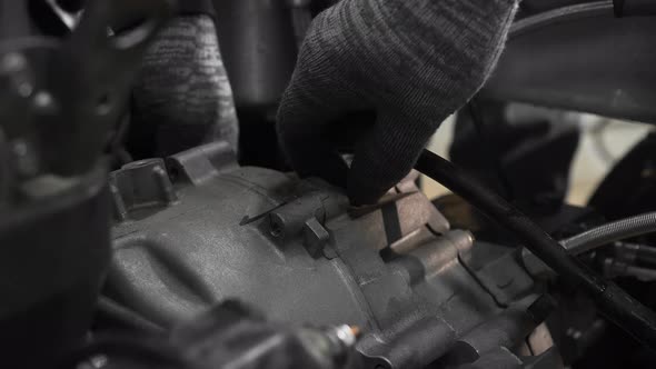 Mechanics in a Car Workshop Disassemble the Gearbox in the Engine of a Tricycle alt