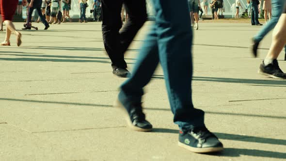 crowd of people walking on sunny streets