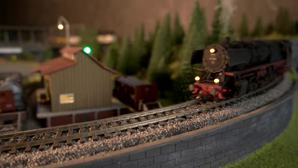 Miniature Freight Train Moving on Miniature Railroad. alt