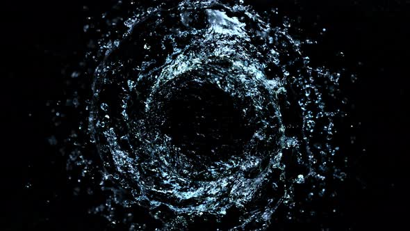 Super Slow Motion Shot of Rotating Water Splash Isolated on Black Background at 1000Fps alt