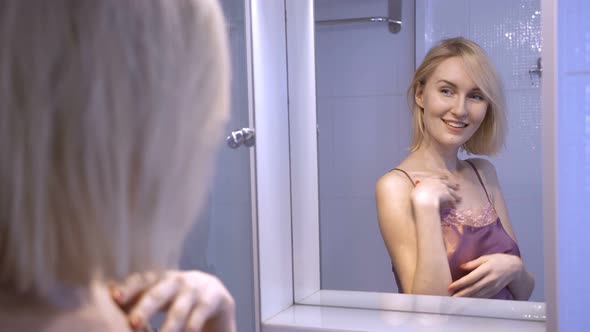 Confident Vain Woman Admiring Herself in Mirror alt