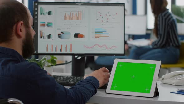 Paralyzed Manager Analysing Statistics Looking at Tablet with Izolated Display alt