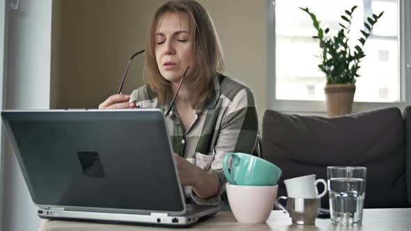 Very Tired Business Woman Working with Laptop at Home alt