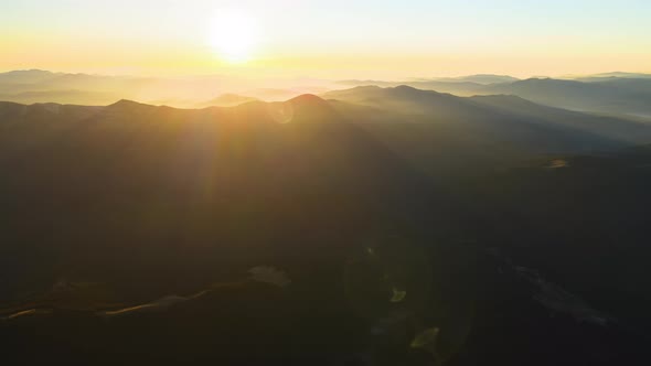 Beautiful Mountain Panoramic Landscape with Hazy Peaks and Foggy Valley at Sunset alt