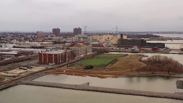 a high pullaway shot, which then pans right over the waters of the Upper Bay, near Bush Terminal Par alt