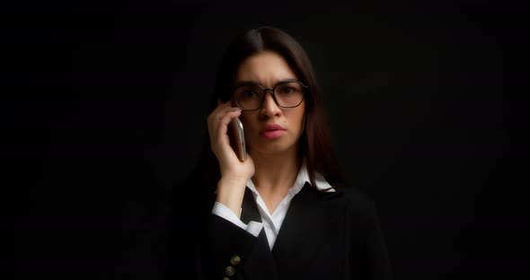 Business Woman Talks on a Smartphone and Shows No with Her Index Finger