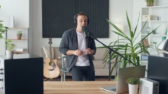 An Influential Male Vlog Performs aMusic Show Broadcasts to an Internet Audience alt