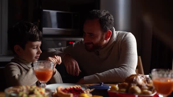 View From Back of Unrecognizable Loving Mother Watching to Cheerful Husband and Son Fooling Playing alt