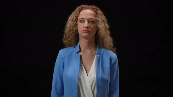 Haughty Caucasian Woman Standing in Camera Flashes at Black Background Looking Around alt