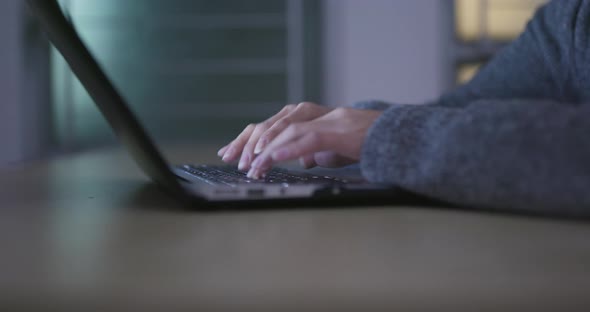 Working on laptop computer at home in the evening alt