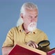 Old Man Looking At Book With Magnifying Glass 1 - VideoHive Item for Sale