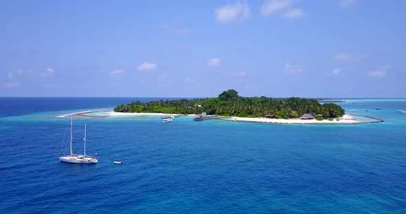Anchored yacht with sails down on paradise bay of tropical island with white sandy beach, lush veget alt