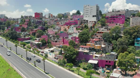 Aerial View on the Road Along Hot Pink Slum Suburban on the Hill in Mexico City alt