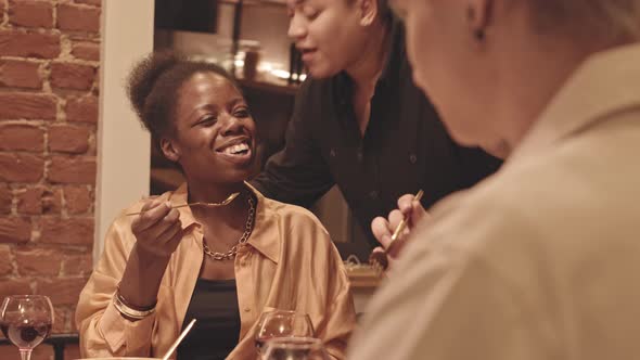 Lesbian and Gay Couple Having Dinner Party Together alt