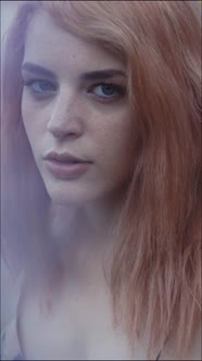 Sensual young redhead portrait looking at camera alt