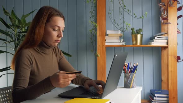 Woman Sit at Desk Using Credit Card and Laptop Make Online Epayment