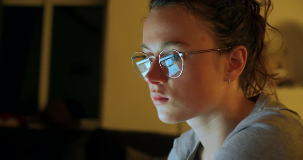 Reflection in Glasses of Woman Working on Computer alt