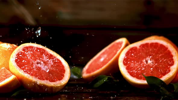 Super Slow Motion on a Piece of Fresh Grapefruit Dripping Water alt
