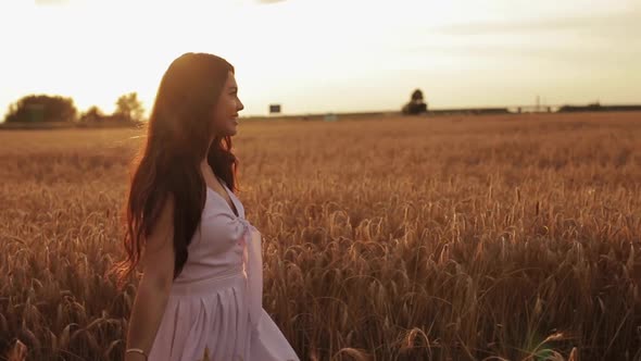 Gorgeous Brunette Walking in the Field.