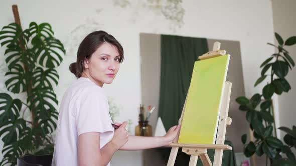 A Young Artist Paints an Abstract Picture in a Creative Studio