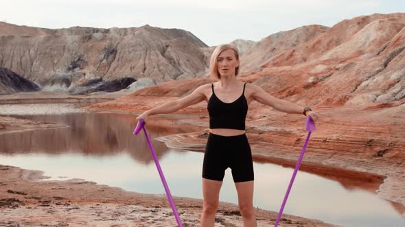 Woman working out on lifeless dried locality