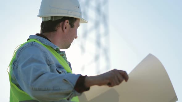 Architect Worker Checking Construction Project On Electric Tower alt