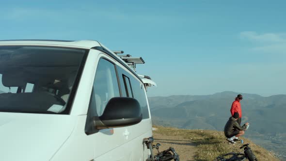 Active Outdoor Friends Watch Sunset From Hill Top alt