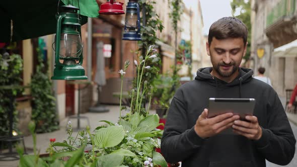 Handsome Bearded Man with Tablet in the Streets Portrait of Confident Smiling alt