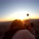 Girl taking pictures in hot air balloon at sunrise, Cappadocia, Turkey - VideoHive Item for Sale