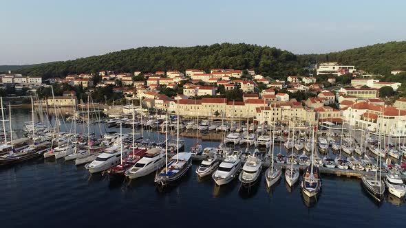 Aerial cinematic view of port full of sailboats, yachts and boats in Croatia, France, Italy or Greec