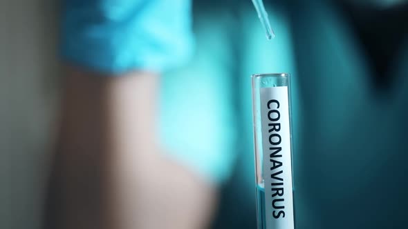 Doctor taking samples from coronavirus COVID-19 test tube