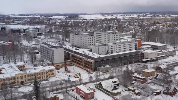Drone shot of Tartus Maarjamõisa hospital during winter, 180 degrees shot of it. alt